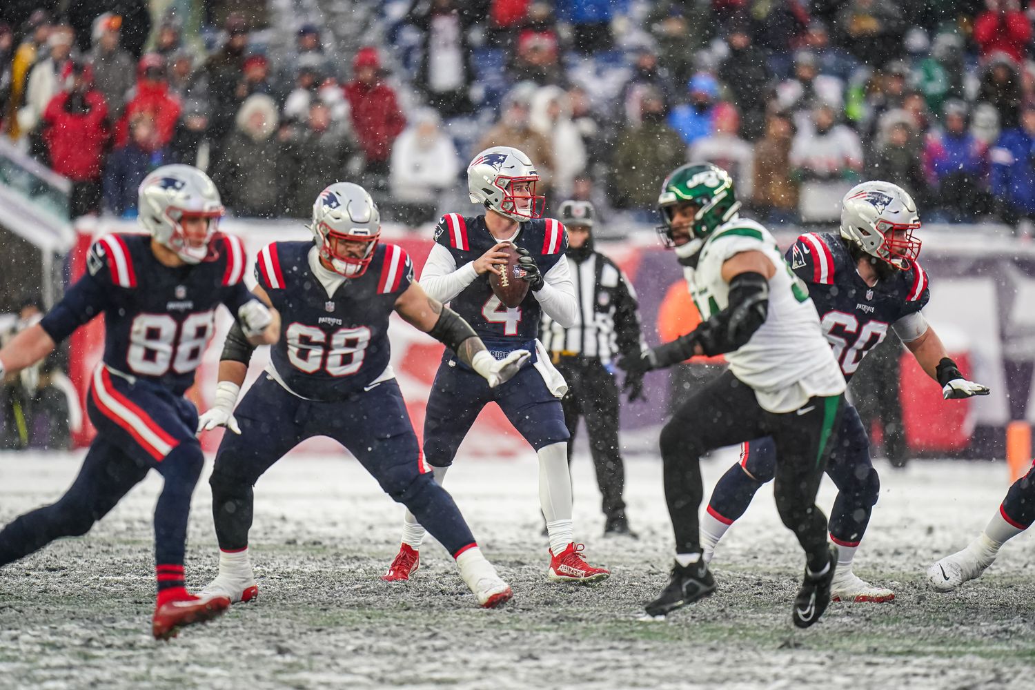 New England Patriots quarterback Bailey Zappe (4) looks to pass the ball against the New York Jets in the second half at Gillette Stadium.